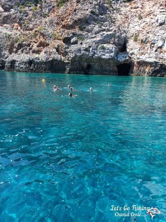 Let's Go Fishing people swimming in greek island waters. Crete